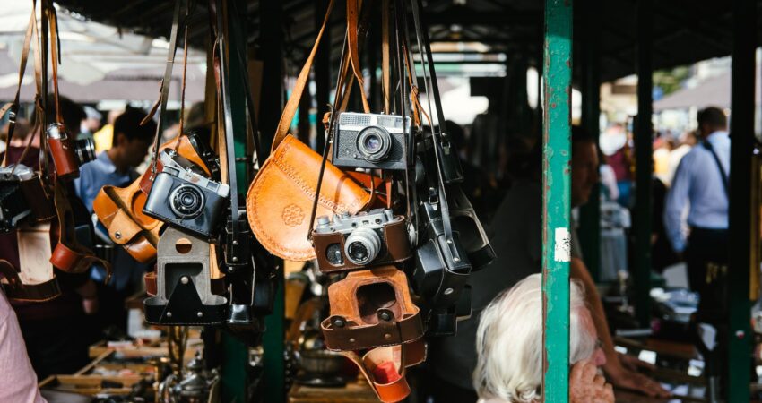 people standing near store and different cameras hanging